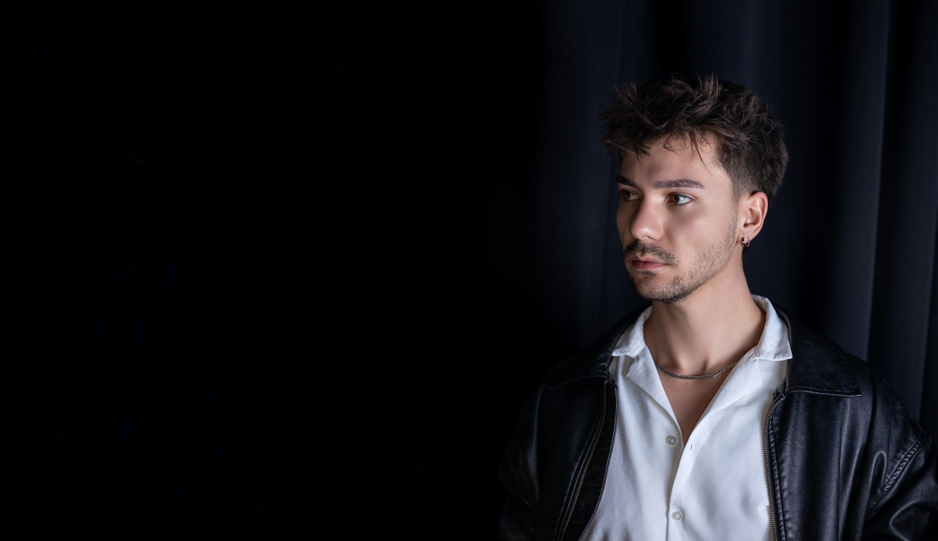 Editorial studio portrait in low, warm light